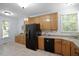 Well-lit kitchen with wooden cabinets, tile flooring, and plenty of countertop space at 1402 Princess Anne Rd, Cary, NC 27513
