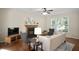Comfortable living room featuring hardwood floors, a fireplace, and expansive windows for natural light and neighborhood views at 1402 Princess Anne Rd, Cary, NC 27513