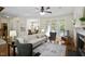 A spacious living room with hardwood flooring, a fireplace, and bright windows that provide ample natural light at 1402 Princess Anne Rd, Cary, NC 27513