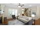 Cozy living room with fireplace, hardwood floors, and large windows for natural light at 1402 Princess Anne Rd, Cary, NC 27513