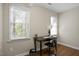 Home office with hardwood floors, a desk, and two large windows at 1402 Princess Anne Rd, Cary, NC 27513