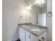 Bathroom featuring double sinks with granite countertop and white cabinetry at 1758 Daiquiri Turn, Sanford, NC 27332