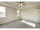 A light filled bedroom with large windows and neutral colored walls and carpet at 1758 Daiquiri Turn, Sanford, NC 27332