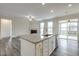 Open kitchen with large island, stainless appliances, and a view to the living room fireplace at 1758 Daiquiri Turn, Sanford, NC 27332