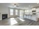 Open-concept living room boasts a fireplace and flows into a kitchen with island and a screened-in porch at 1758 Daiquiri Turn, Sanford, NC 27332