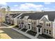 New townhome community with manicured lawns and convenient walking paths under a bright sky at 231 Frosted Iris Lane Ln # 174, Garner, NC 27529