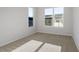 Bright bedroom with neutral carpet, two windows, and white walls at 231 Frosted Iris Lane Ln # 174, Garner, NC 27529