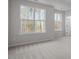 Bedroom featuring two windows showcasing natural light and plush neutral carpeting at 231 Frosted Iris Lane Ln # 174, Garner, NC 27529