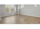 Bedroom with hardwood floors, three windows, and neutral wall color at 231 Frosted Iris Lane Ln # 174, Garner, NC 27529