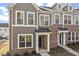 Charming townhome featuring brick and vertical siding, covered entrance, and large windows at 231 Frosted Iris Lane Ln # 174, Garner, NC 27529