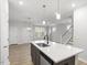 Kitchen island with hardwood floors and white countertops at 231 Frosted Iris Lane Ln # 174, Garner, NC 27529
