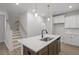 Kitchen island with stainless steel appliances and white countertops at 231 Frosted Iris Lane Ln # 174, Garner, NC 27529