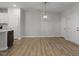 Spacious living room featuring modern light fixture and wood flooring at 231 Frosted Iris Lane Ln # 174, Garner, NC 27529