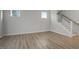 Open living room with hardwood floors and white staircase to second floor at 231 Frosted Iris Lane Ln # 174, Garner, NC 27529