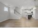 Open concept living room and kitchen with hardwood floors and white cabinetry at 231 Frosted Iris Lane Ln # 174, Garner, NC 27529