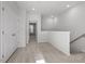 Bright loft area with plush carpeting and ample natural light from nearby windows at 231 Frosted Iris Lane Ln # 174, Garner, NC 27529