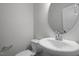 Elegant half bath with pedestal sink, modern faucet, and decorative mirror at 231 Frosted Iris Lane Ln # 174, Garner, NC 27529