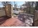 Large wooden back deck featuring a stone fireplace, great for outdoor enjoyment at 2701 Erinridge Road Rd, Raleigh, NC 27610