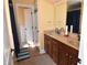 Bathroom featuring double sinks with wooden cabinets and a linen closet at 2701 Erinridge Road Rd, Raleigh, NC 27610