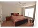 Comfortable bedroom with ceiling fan, window, and a wooden sleigh bed at 2701 Erinridge Road Rd, Raleigh, NC 27610