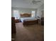 Spacious bedroom with hardwood furniture, and two windows for natural light at 2701 Erinridge Road Rd, Raleigh, NC 27610