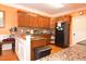 View of kitchen featuring wooden cabinets, granite countertops, and stainless steel appliances at 2701 Erinridge Road Rd, Raleigh, NC 27610