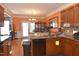 A well-lit kitchen showcases wooden cabinets, granite countertops, and access to the backyard at 2701 Erinridge Road Rd, Raleigh, NC 27610