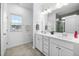 Bright bathroom with double sinks, a large mirror, and a shower at 2959 Sunflower Rd, Apex, NC 27502