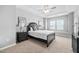 Beautiful bedroom featuring a tray ceiling, ceiling fan, and large window for ample natural light at 2959 Sunflower Rd, Apex, NC 27502