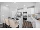 Modern white kitchen with an island, stainless steel appliances, and tile backsplash at 2959 Sunflower Rd, Apex, NC 27502