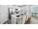 Bright kitchen with island seating, stainless steel appliances, and sleek white cabinetry at 2959 Sunflower Rd, Apex, NC 27502