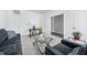 Cozy living room with comfortable seating, a glass table, and a view into the next room at 2959 Sunflower Rd, Apex, NC 27502