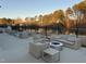 Outdoor lounge area with multiple seating arrangements overlooking a serene lake at 2959 Sunflower Rd, Apex, NC 27502