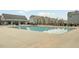 Community pool, clubhouse, and townhomes under a clear sky at 2959 Sunflower Rd, Apex, NC 27502