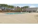 Community pool with spacious sun deck, surrounded by trees and amenities at 2959 Sunflower Rd, Apex, NC 27502
