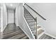 Elegant staircase with wood treads, black iron balusters, and gray walls at 2959 Sunflower Rd, Apex, NC 27502