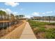 Scenic community walking path along a lake with views of the surrounding neighborhood at 2959 Sunflower Rd, Apex, NC 27502
