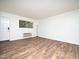Bright living room with sleek wood flooring, a door, a large window, and an air conditioner at 3 Shepherd Ln # Bldg C, Chapel Hill, NC 27514
