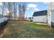 A fenced backyard with a mix of grass and natural areas, providing privacy and space for outdoor activities at 304 Ashley Woods Ct, Clayton, NC 27527