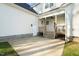 The backyard has a covered patio with a ceiling fan and adjacent utility door at 304 Ashley Woods Ct, Clayton, NC 27527