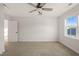 Neutral bedroom with plush carpeting, a ceiling fan, natural light, and a smooth, painted finish at 304 Ashley Woods Ct, Clayton, NC 27527