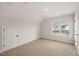 Bright bedroom features neutral carpeting, window with neighborhood view, and closet at 304 Ashley Woods Ct, Clayton, NC 27527