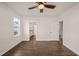 This bright bedroom boasts smooth wood floors, a modern ceiling fan, and a view of the neighborhood at 304 Ashley Woods Ct, Clayton, NC 27527