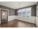 Elegant dining room with dark walls, hardwood flooring, and three large windows at 304 Ashley Woods Ct, Clayton, NC 27527