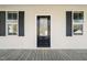 Close up of front door, black shutters and front porch at 304 Ashley Woods Ct, Clayton, NC 27527