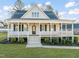 Inviting two-story home with a spacious front porch, manicured landscaping, and a welcoming entrance at 304 Ashley Woods Ct, Clayton, NC 27527
