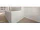 The upstairs hallway has neutral carpet, white trim, and lots of natural light at 304 Ashley Woods Ct, Clayton, NC 27527