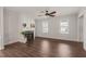 Bright living room features dark, hardwood flooring and fireplace between two large windows at 304 Ashley Woods Ct, Clayton, NC 27527