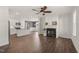 Open-concept living room with hardwood floors, fireplace, and seamless flow to the kitchen and dining area at 304 Ashley Woods Ct, Clayton, NC 27527