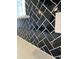 Close-up of the stylish black herringbone backsplash against the white countertops and cabinets at 304 White Oak Garden Way # 214, Garner, NC 27529